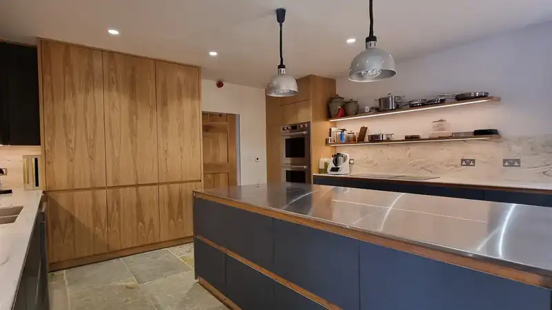Completed Oak veneer and Verde Comodoro kitchen by JS DECO in West Yorkshire