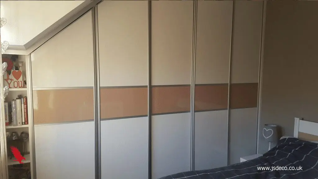 Modern high gloss white and beige wardrobe with sliding doors under slopped ceiling