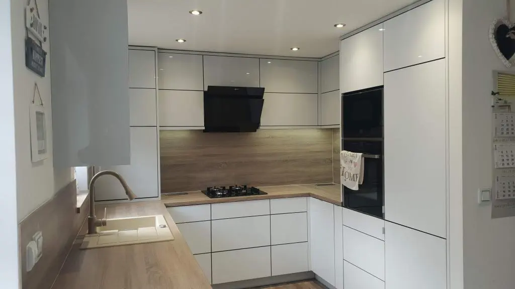 High gloss white and grey handleless bespoke kitchen in Barnsley with oak effect worktops and integrated tall units