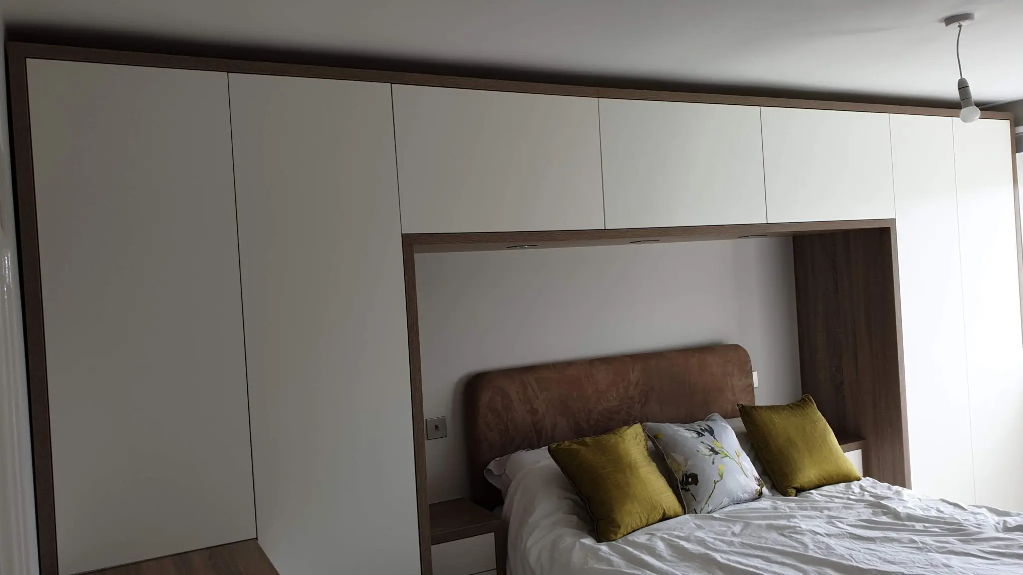 Fitted bedroom furniture with full-height wardrobes and a bridging unit installed in a Silkstone home