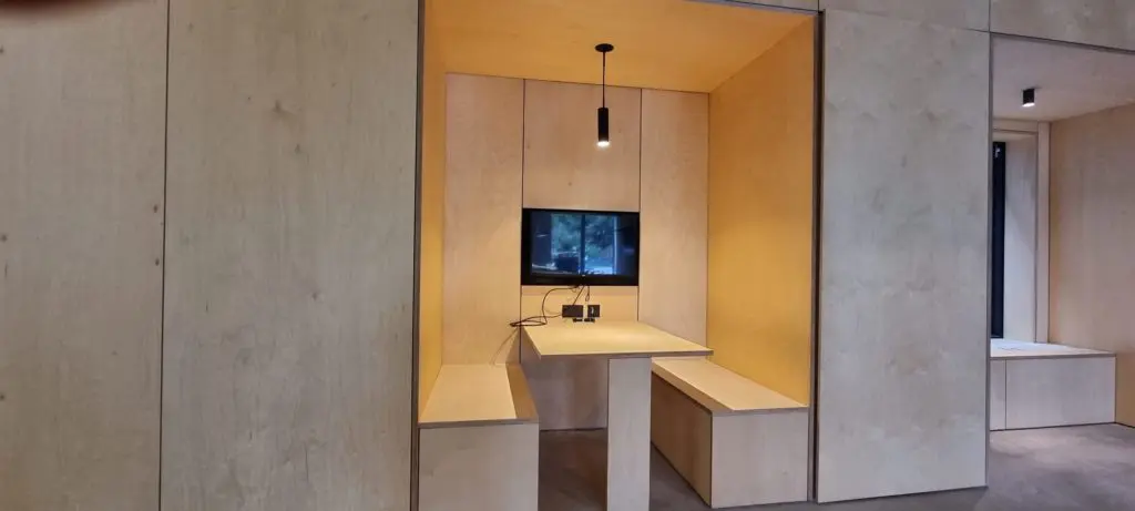 The plywood furniture within the open-plan office at The Place.