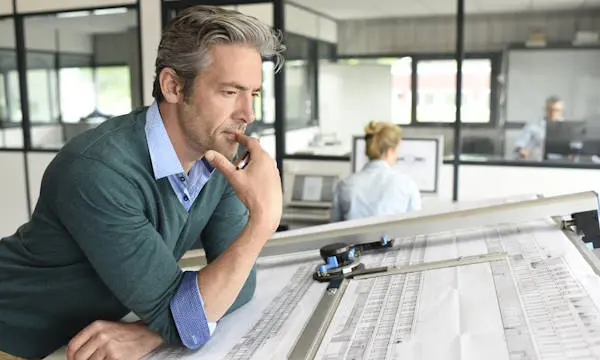 Architect reviewing bespoke furniture plans during trade collaboration with JS DECO, a UK manufacturer based in Wakefield.