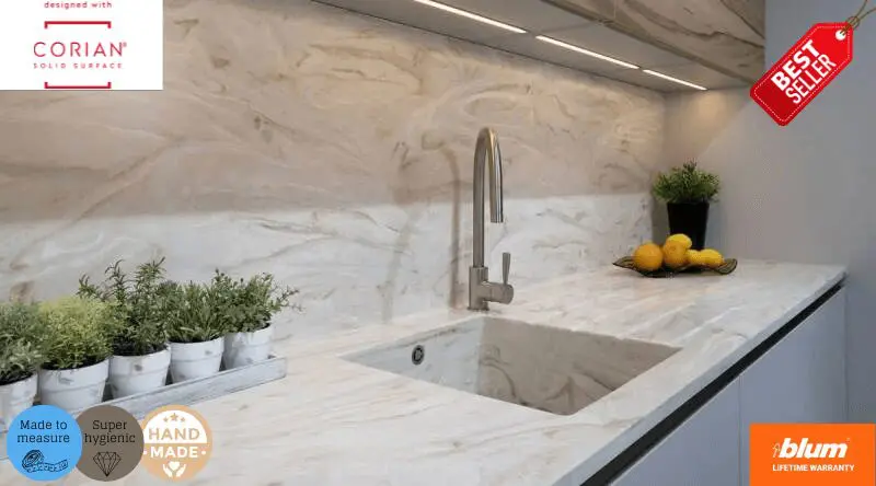 Luxury Corian-clad kitchen with integrated sink and marble-effect solid surface by JS DECO, handcrafted in the UK with Blum hardware.