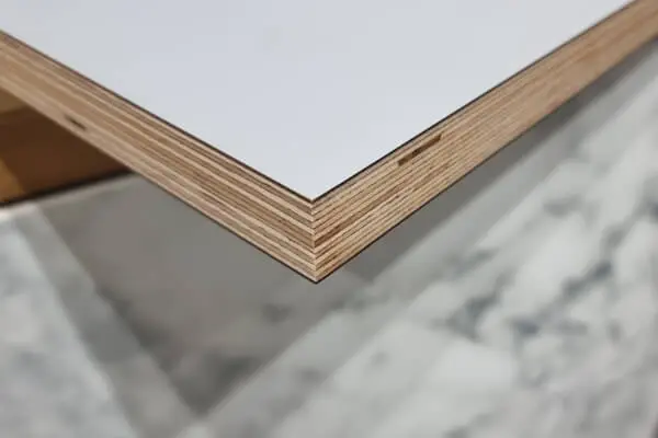 FENIX NTM plywood-core door panel with exposed birch edge and white ultra-matt surface.