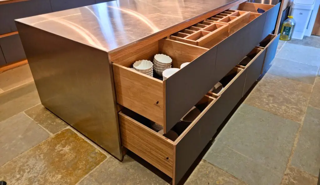 Island drawers provide storage directly below the stainless-steel surface