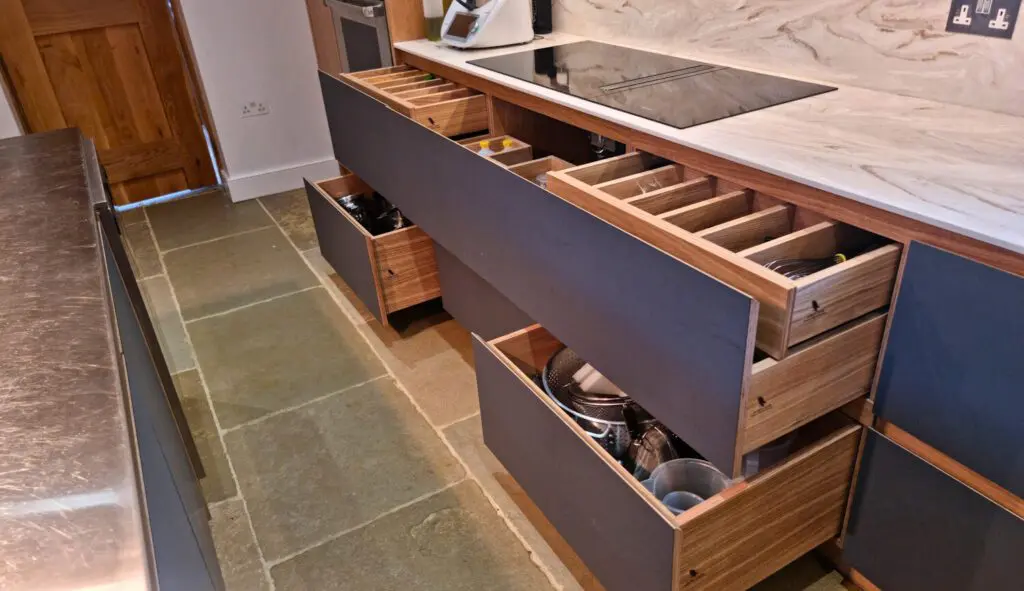 Shallow organisers and deeper drawers beneath the Corian worktop