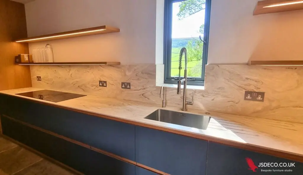 Corian worktop and splashback beneath the window and open shelves