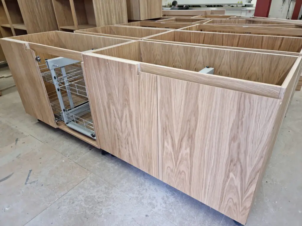Corner pull-out baskets within the oak-veneered cabinet construction