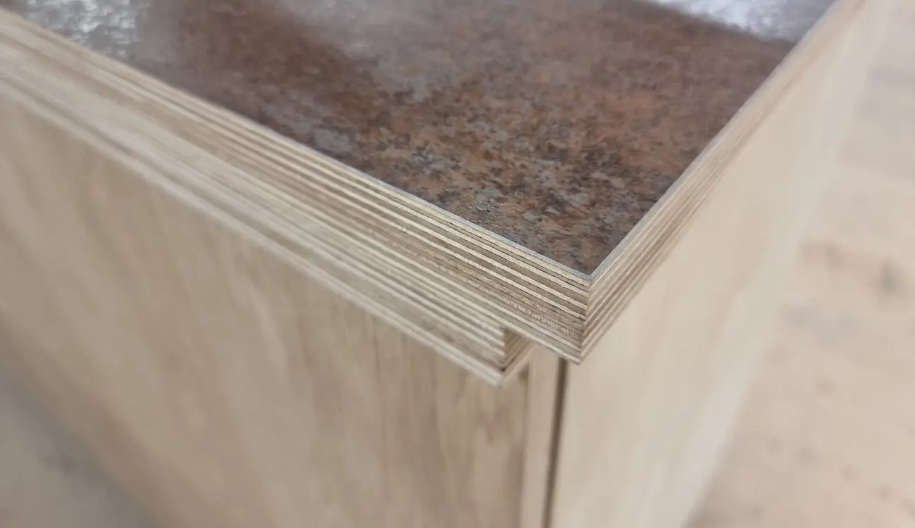 Birch plywood worktop with exposed ply layers and a stone-effect laminate surface, crafted by JS DECO.