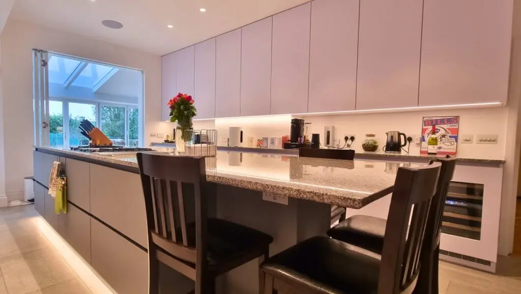 White and grey modern FENIX kitchen with large island and handleless cabinets