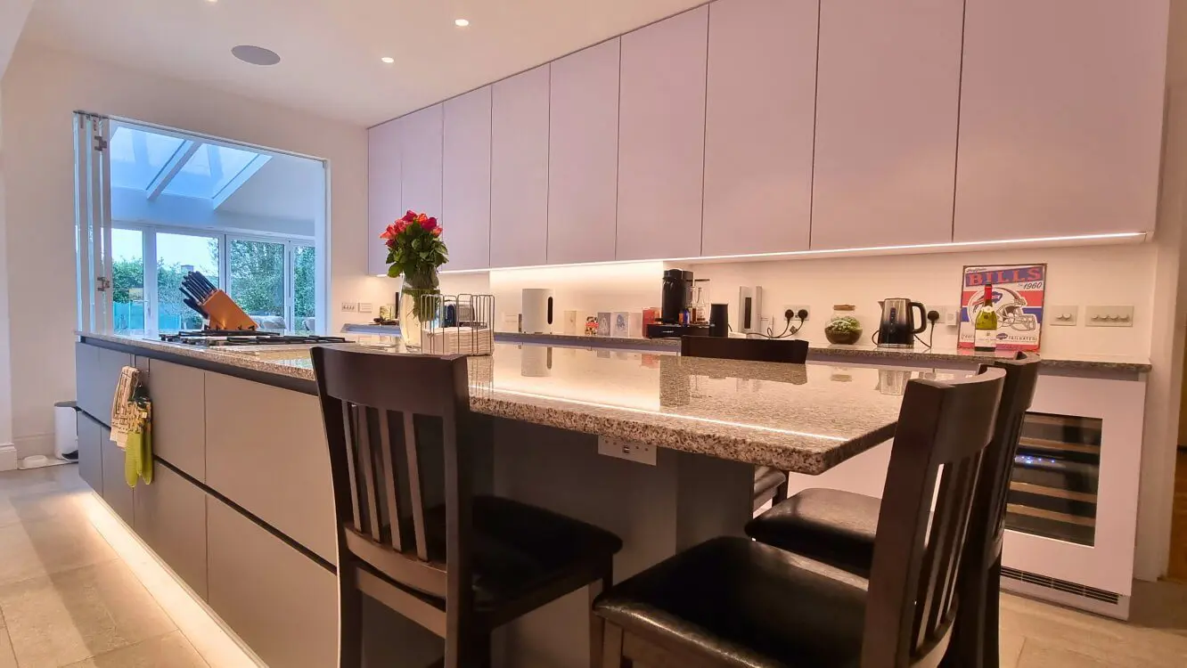 White and grey modern FENIX kitchen with large island and handleless cabinets