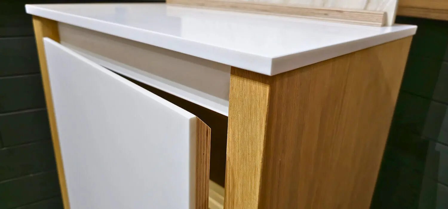 Corian-clad birch plywood kitchen cabinetry made by JS DECO