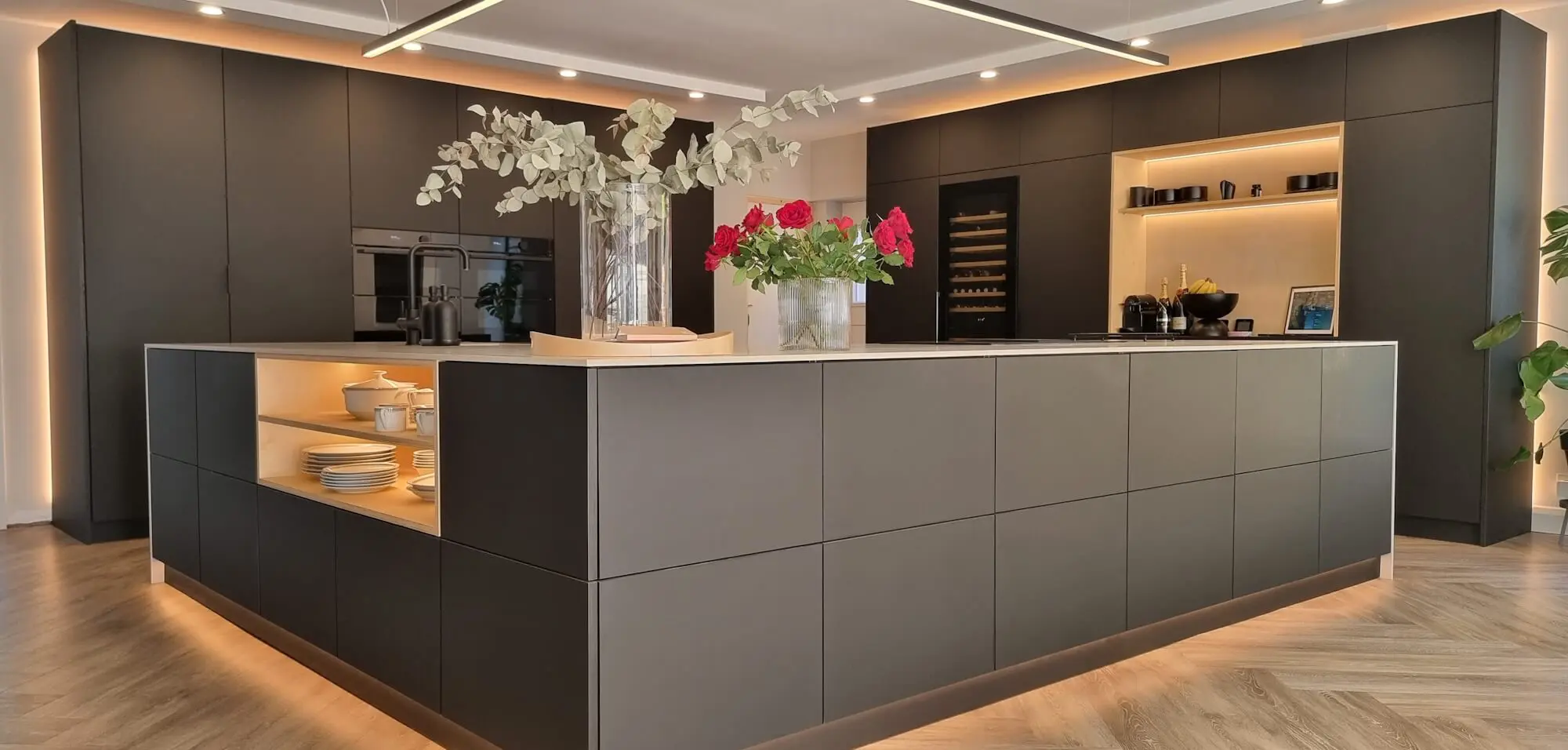 Bespoke FENIX NTM matte handleless kitchen with large island and plywood illuminated niches by JS DECO.