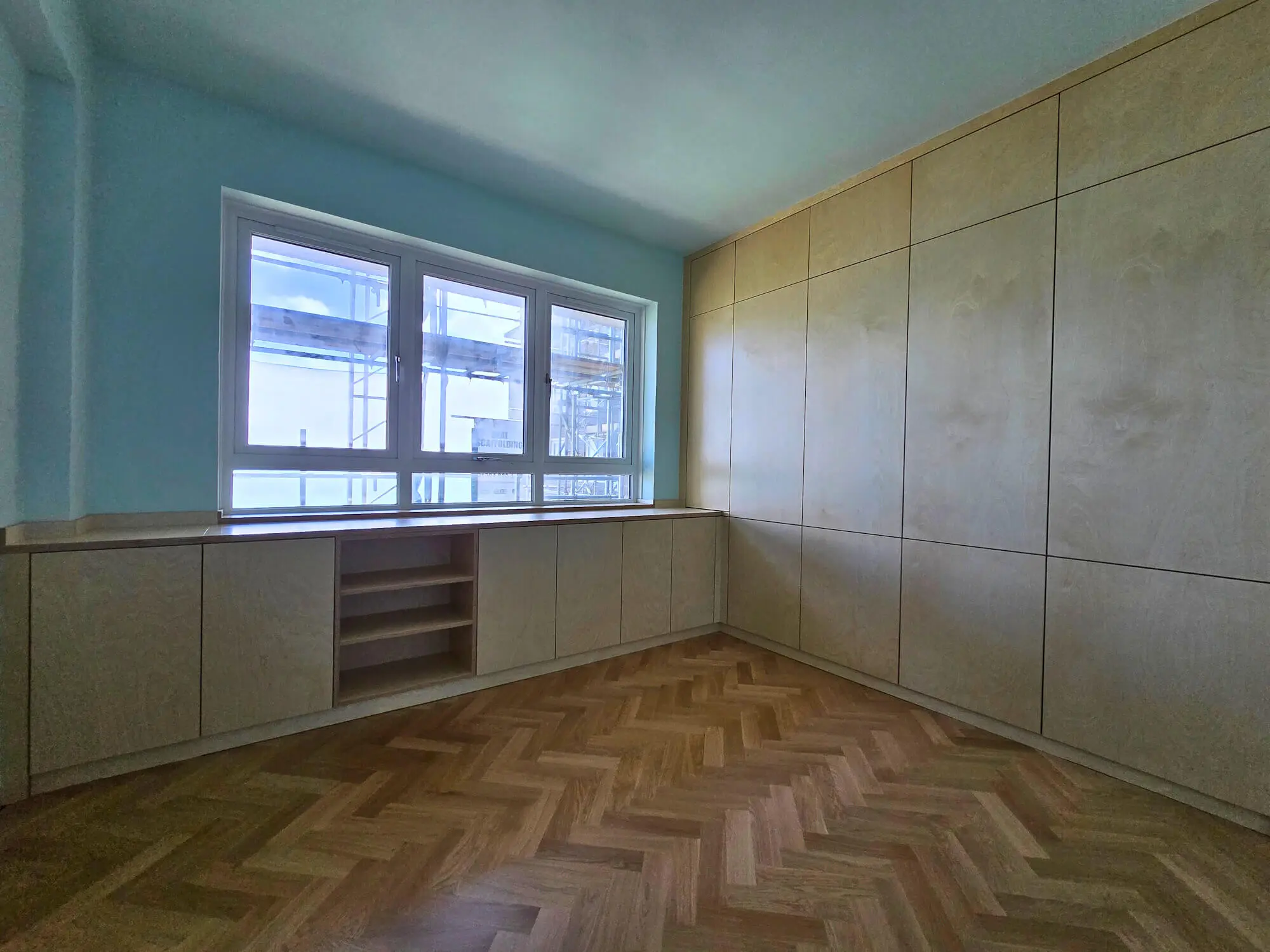 Plywood wardrobes fitted bedroom with worktop under window and soft-close drawers by JS DECO UK