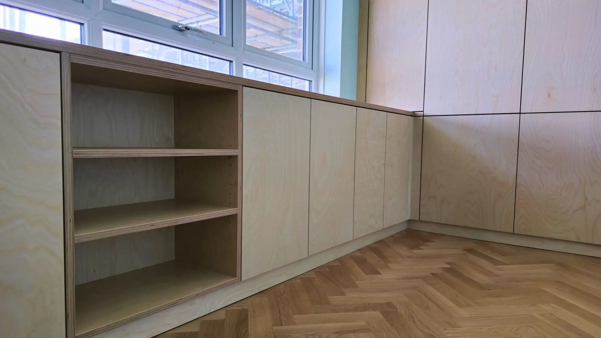 Birch plywood wardrobes fitted under window with adjustable shelving and natural wood finish Dover by JS DECO