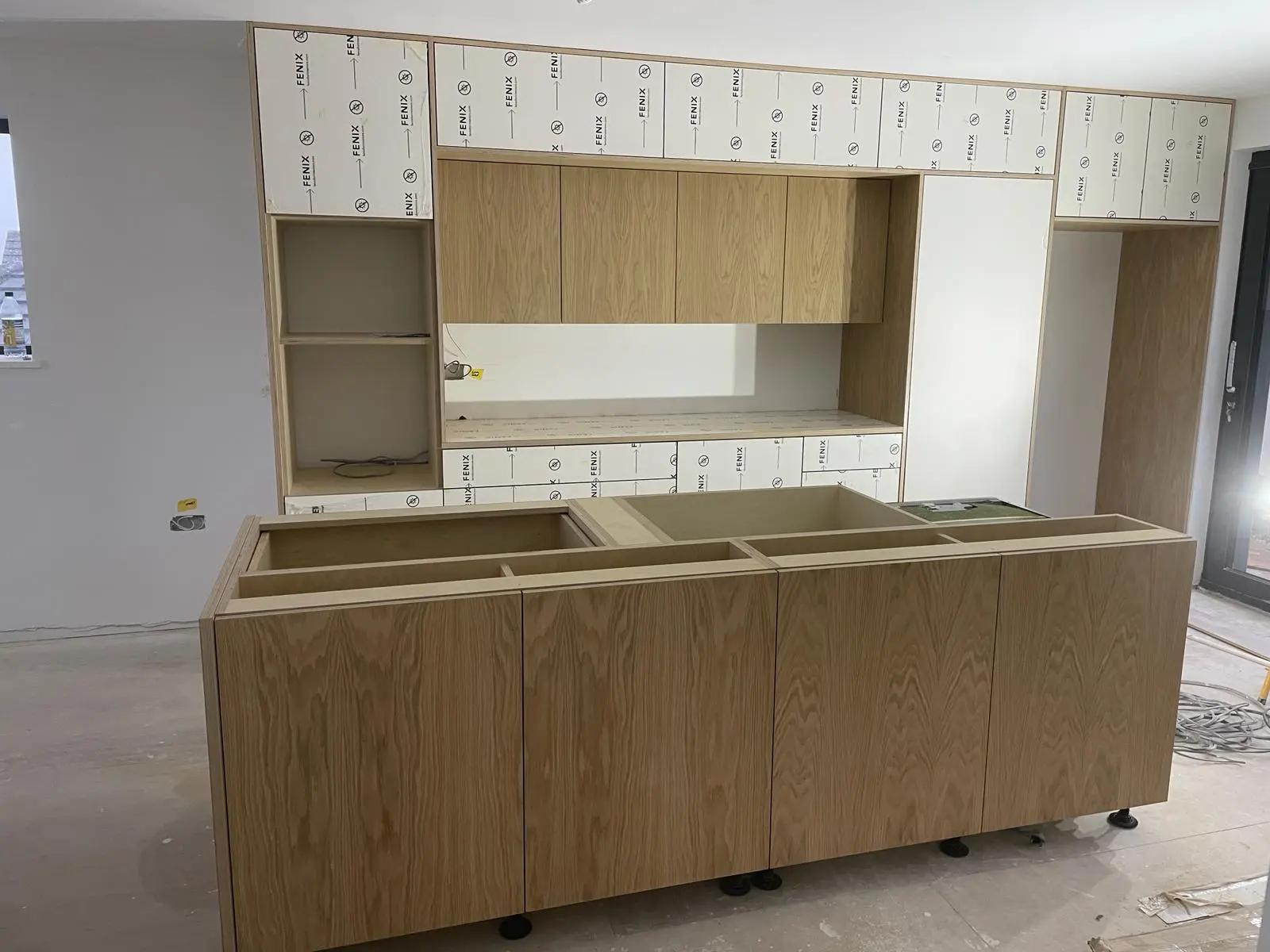 Bespoke kitchen island installation showing plywood construction and oak veneer cabinets Bristol by JS DECO