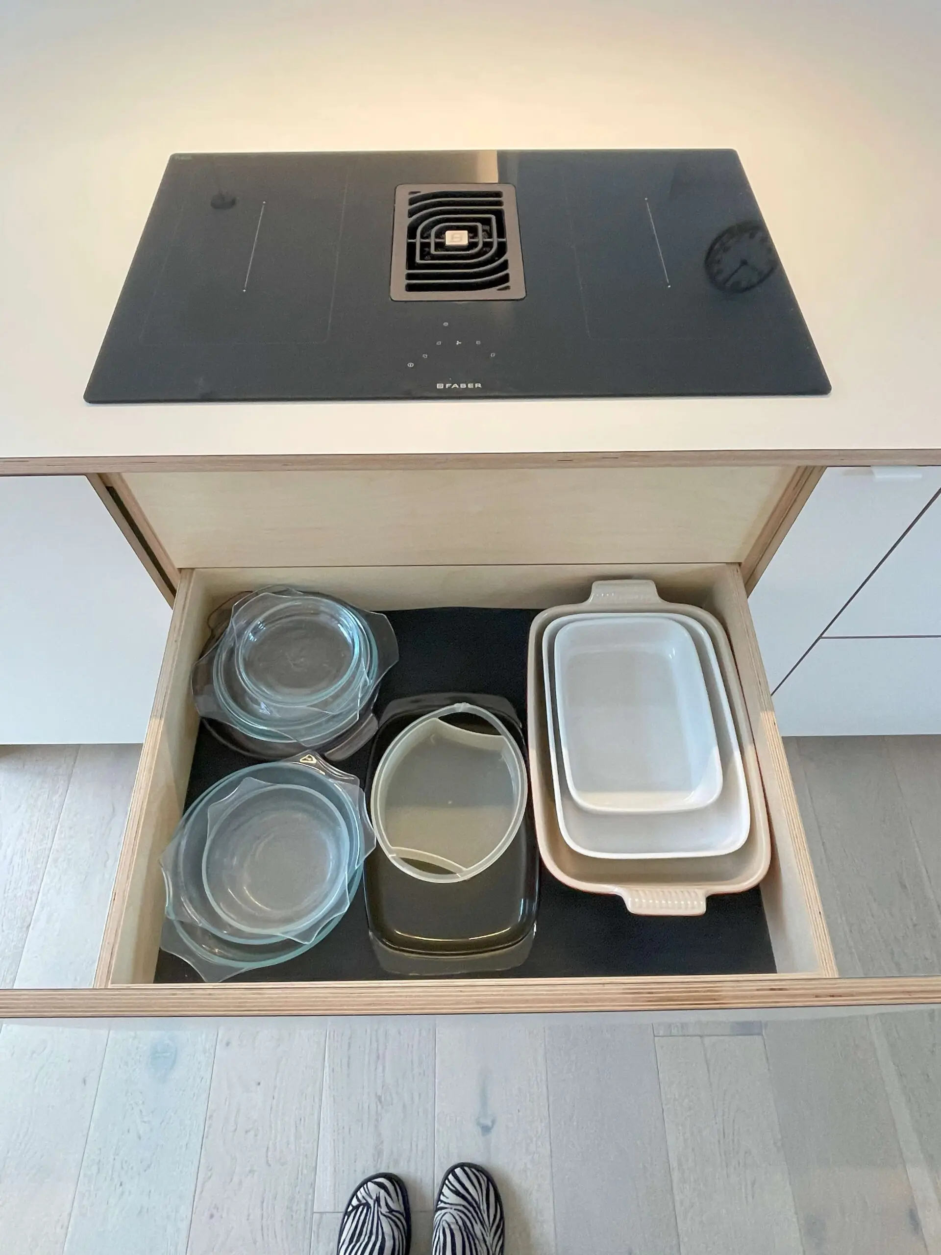 Kitchen drawer organization with custom storage solutions in minimalist Scandinavian kitchen Bristol