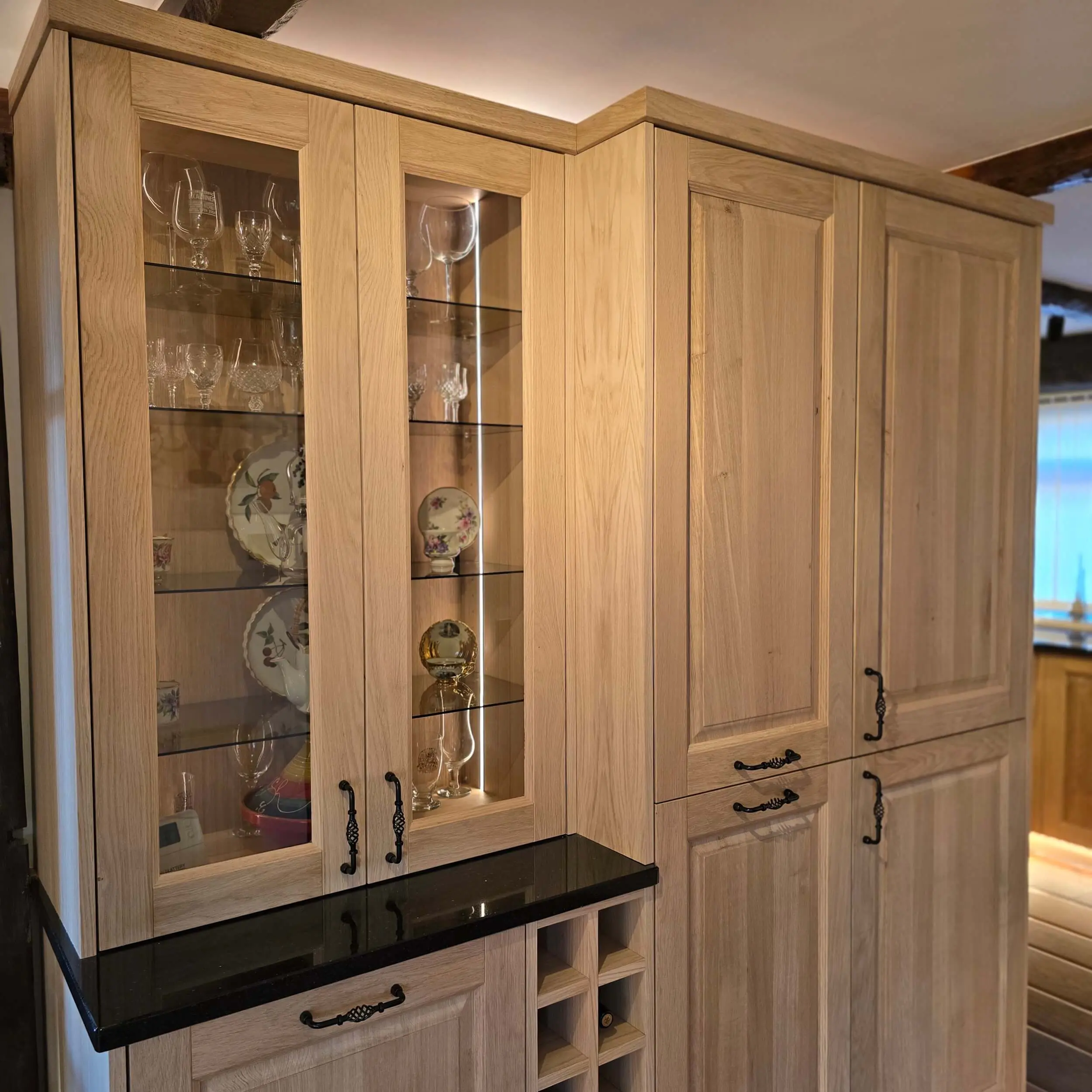 Traditional style oak kitchen with glass display cabinets and wine rack storage in Huddersfield