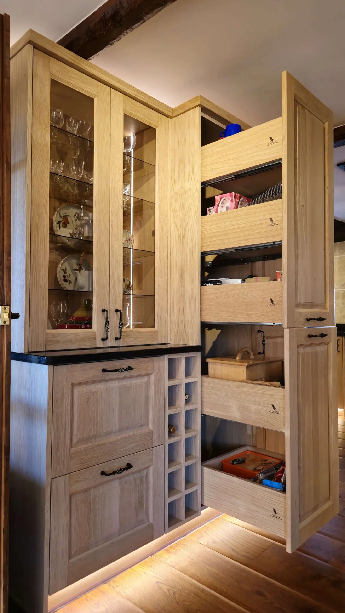 Hand made solid oak kitchen storage system with multiple pull-out shelves and traditional ogee doors