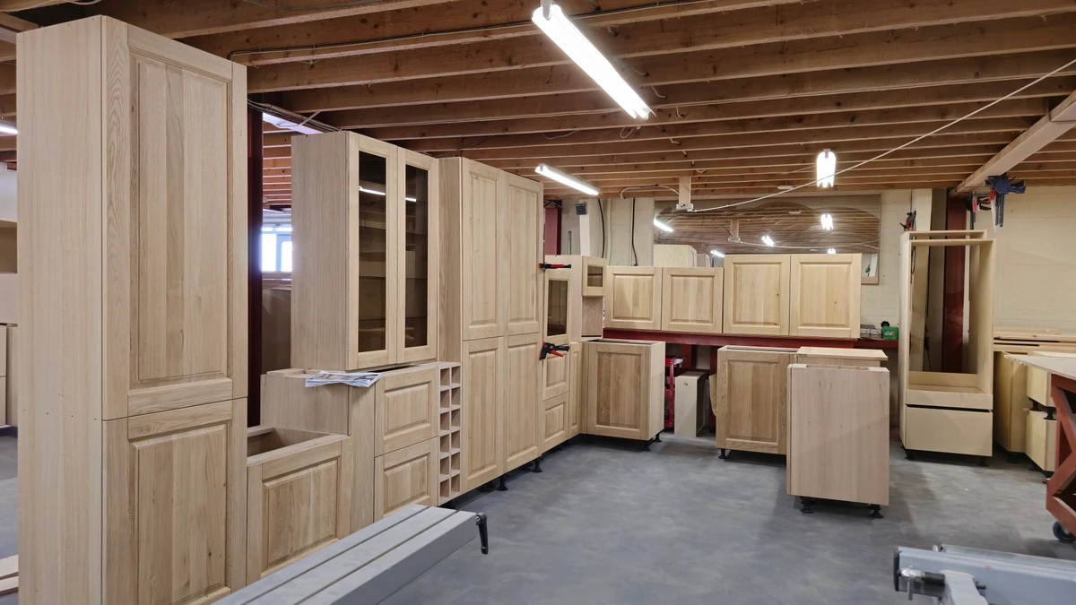 Timber kitchen cabinets with framed doors, drawers and wine storage assembled in the JS DECO Wakefield workshop
