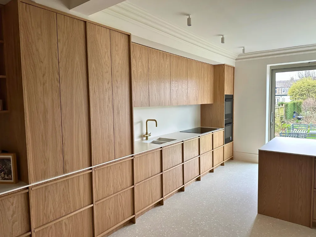 Contemporary bespoke natural oak kitchen with grain-matched cabinetry and island