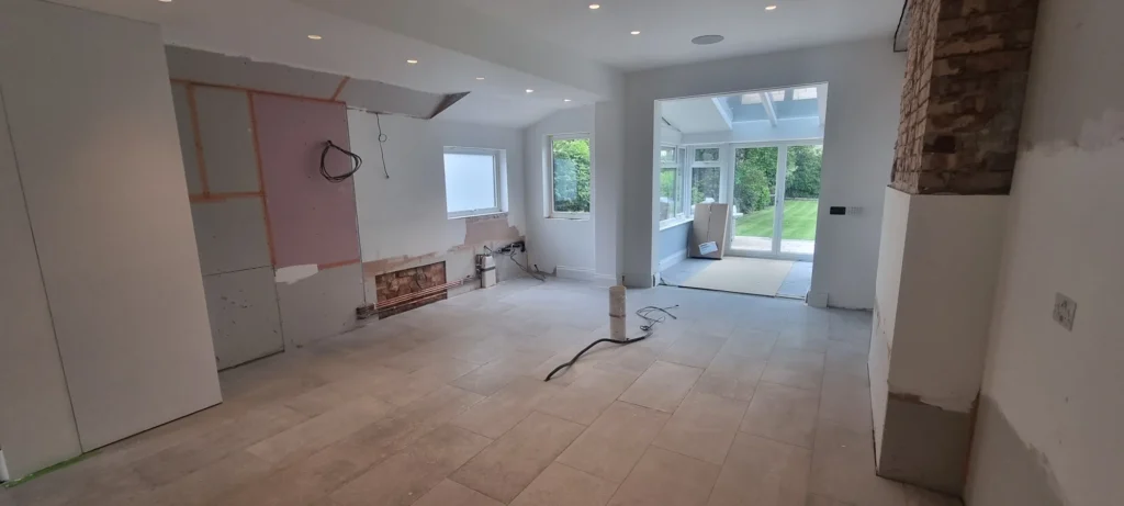 Before kitchen installation: the prepared room with exposed services and unfinished wall areas.