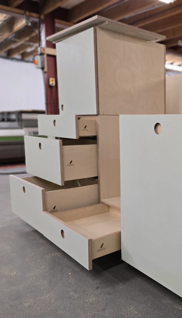 Bespoke workshop manufacturing birch plywood kitchens Stacked drawers in a workshop setting.