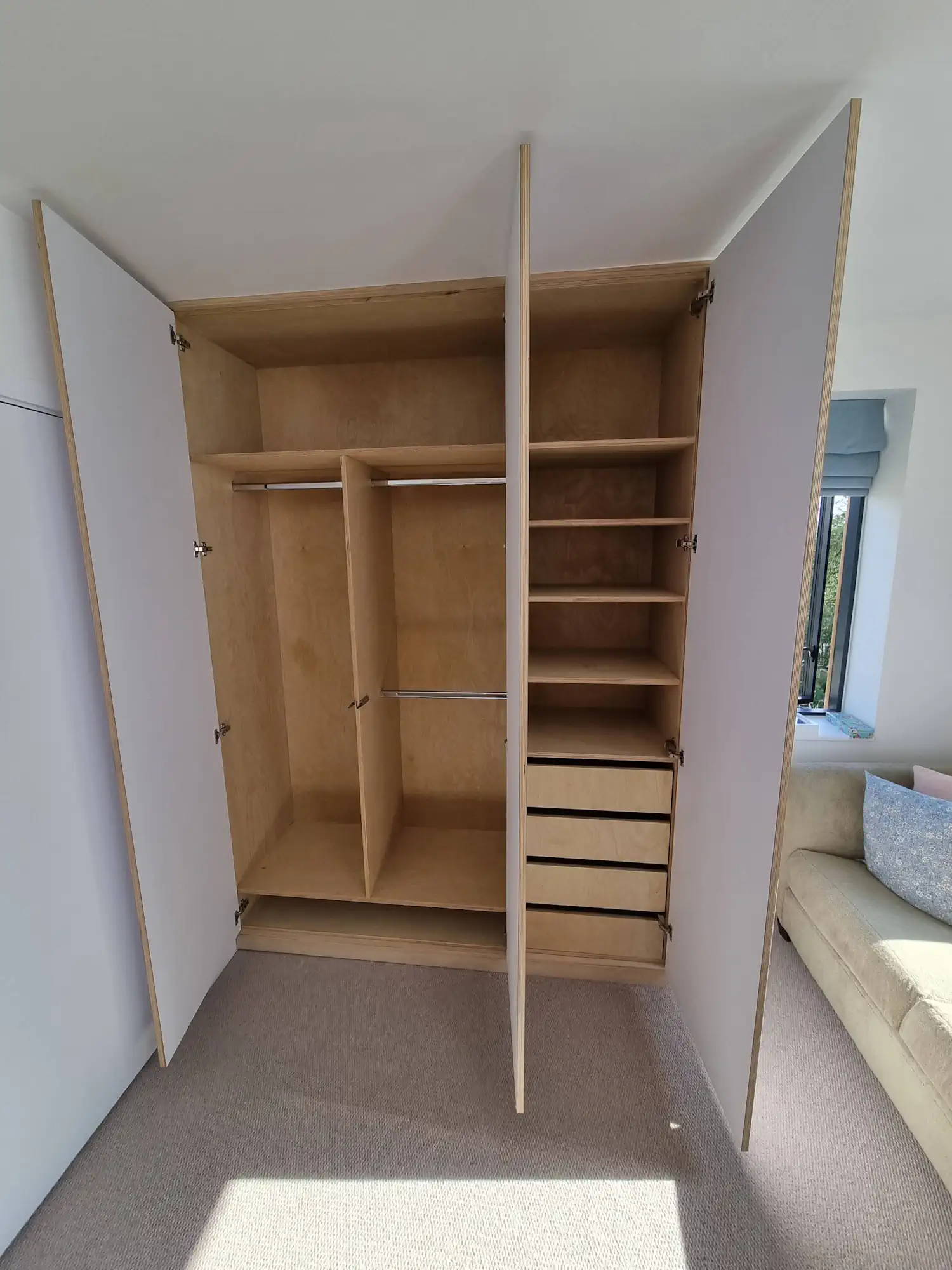 Internall confirguration of modern wardrobe made of 18mm birch plywood and FENIX NTM white laminate