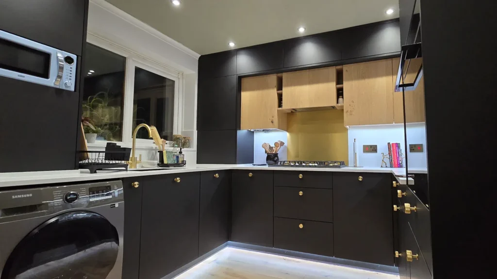 Bespoke FENIX NTM Nero Ingo kitchen with black base units and white Corian worktop