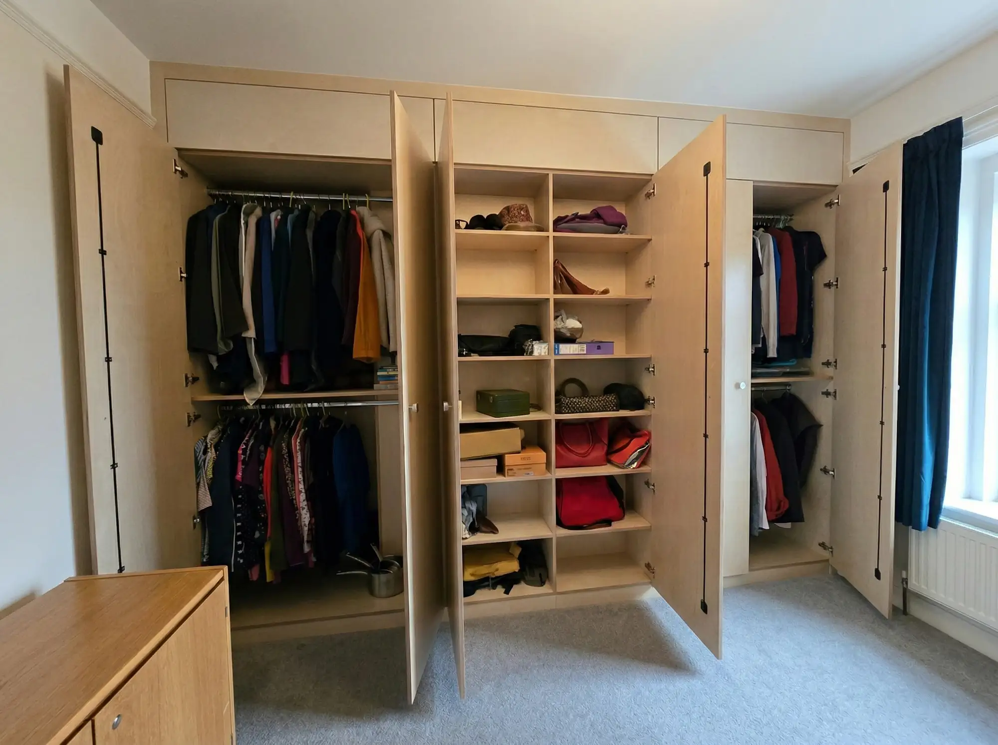 Internall confirguration of hand made plywood wardrobe with extra long doors