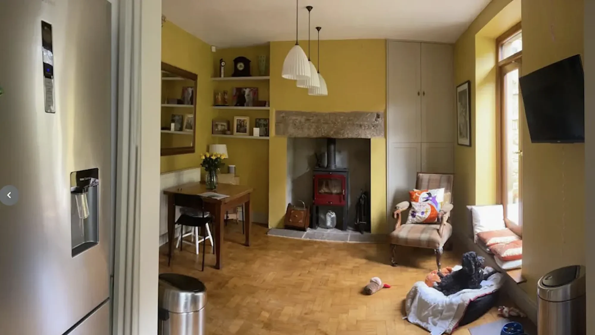 Dining and living area before kitchen renovation in Matlock Yellow painted dining and living room with woodburner before kitchen renovation in Matlock Derbyshire