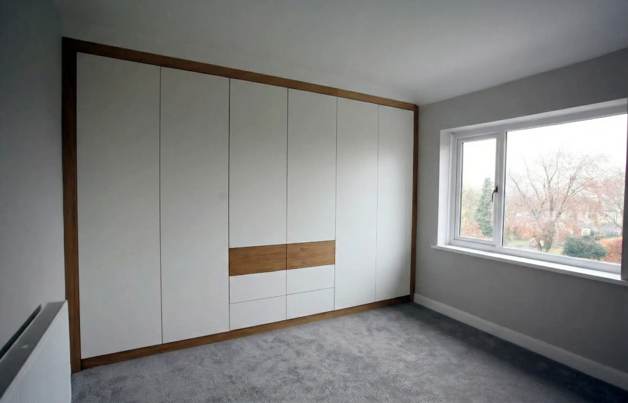Sample of modern style handleless fitted wardrobe with drawers