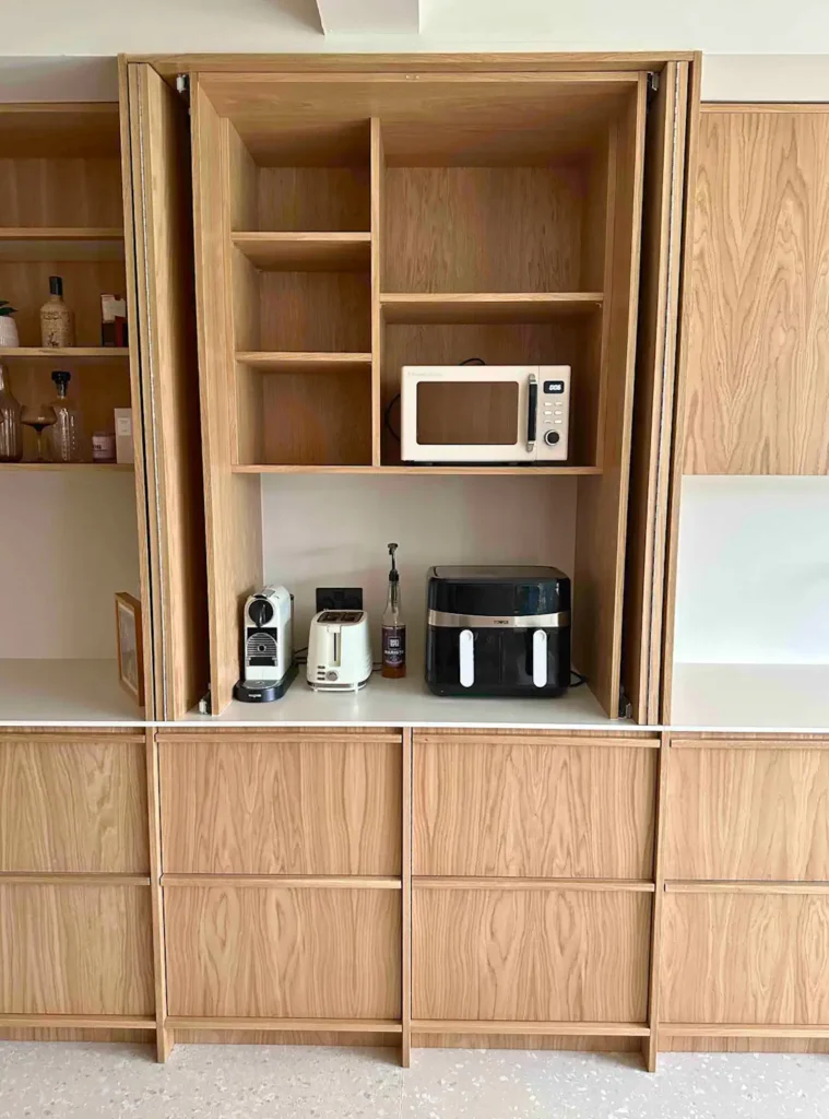 The breakfast cabinet open, showing the internal work surface and storage.