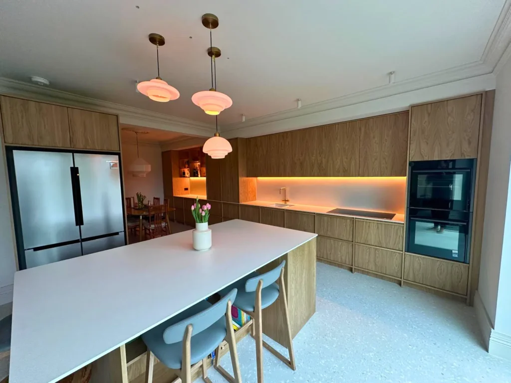 The completed oak kitchen with the lighting switched on.