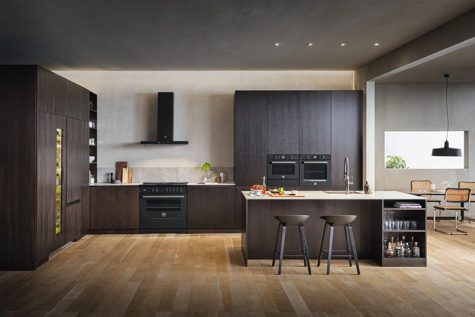Bertazzoni appliances arranged within a dark timber kitchen with an island