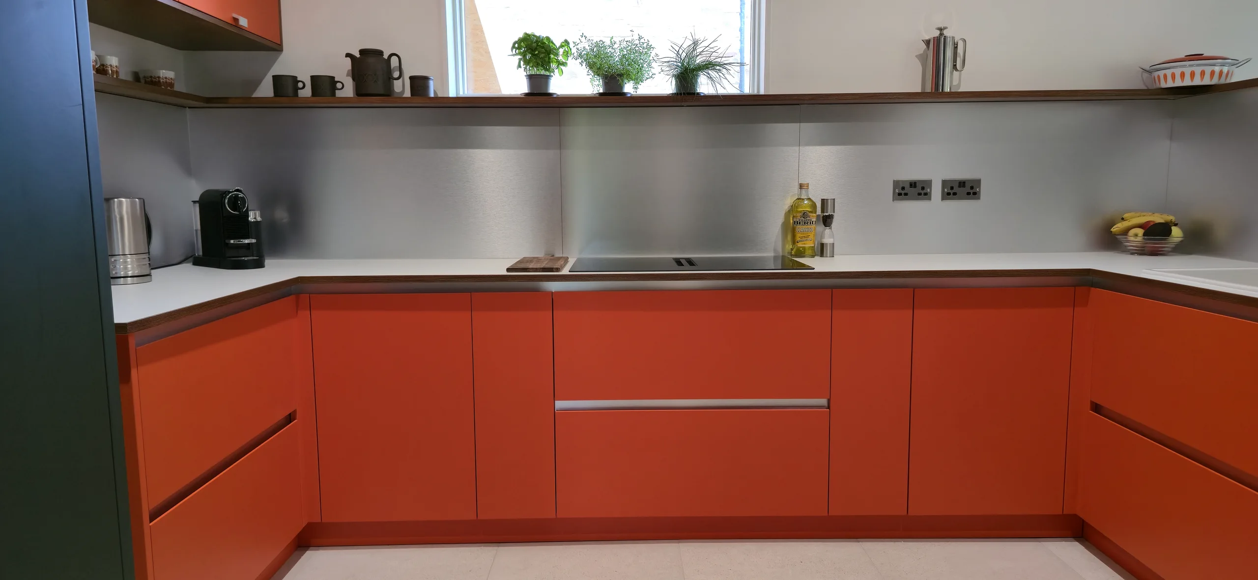 Traffic Orange painted kitchen fronts with birch plywood detail in Cawthorne