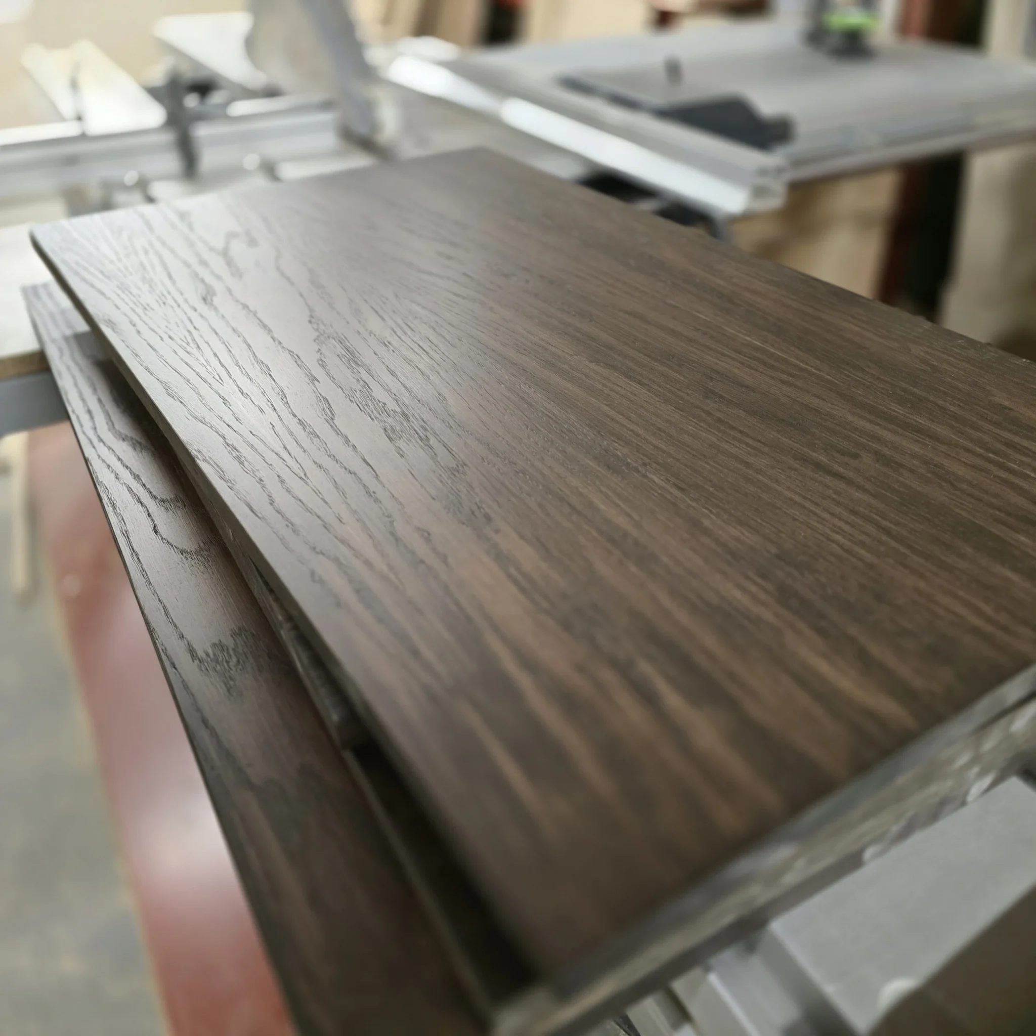 Dark-stained oak veneer during workshop preparation.