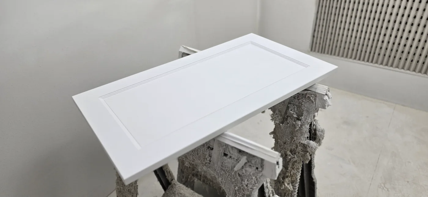 White cabinet door on a support inside the JS DECO spray booth
