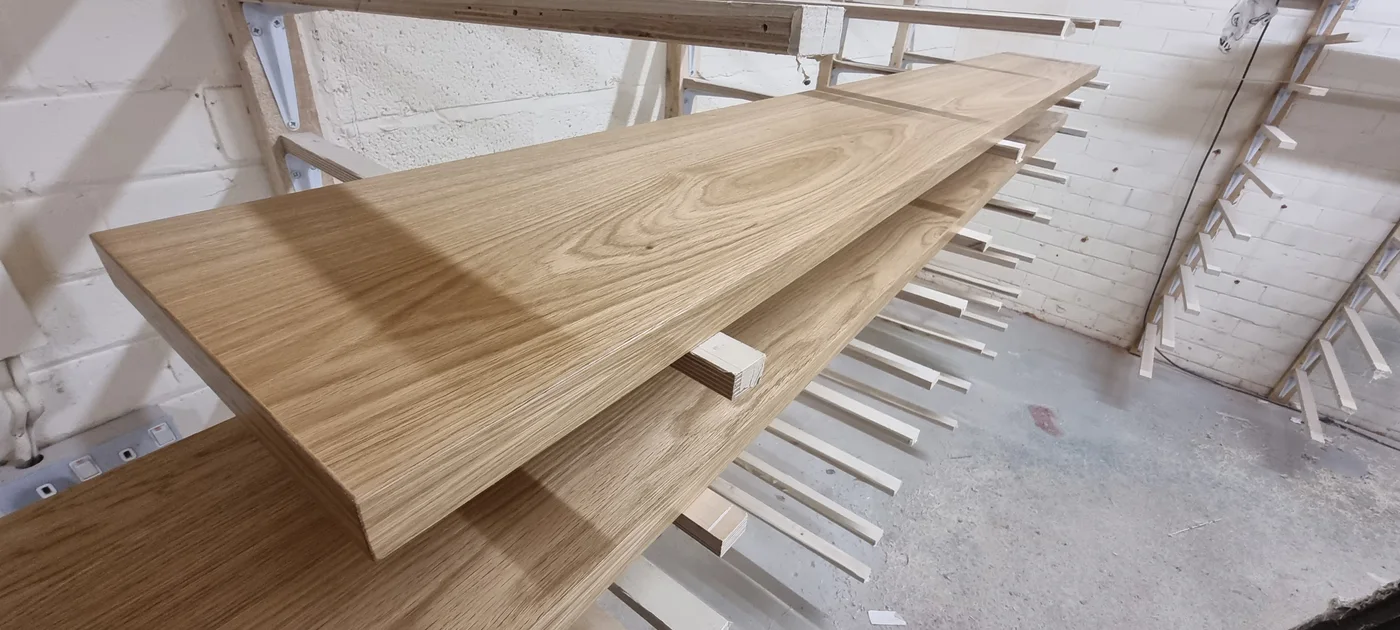 Timber panels resting on racks in the JS DECO finishing department